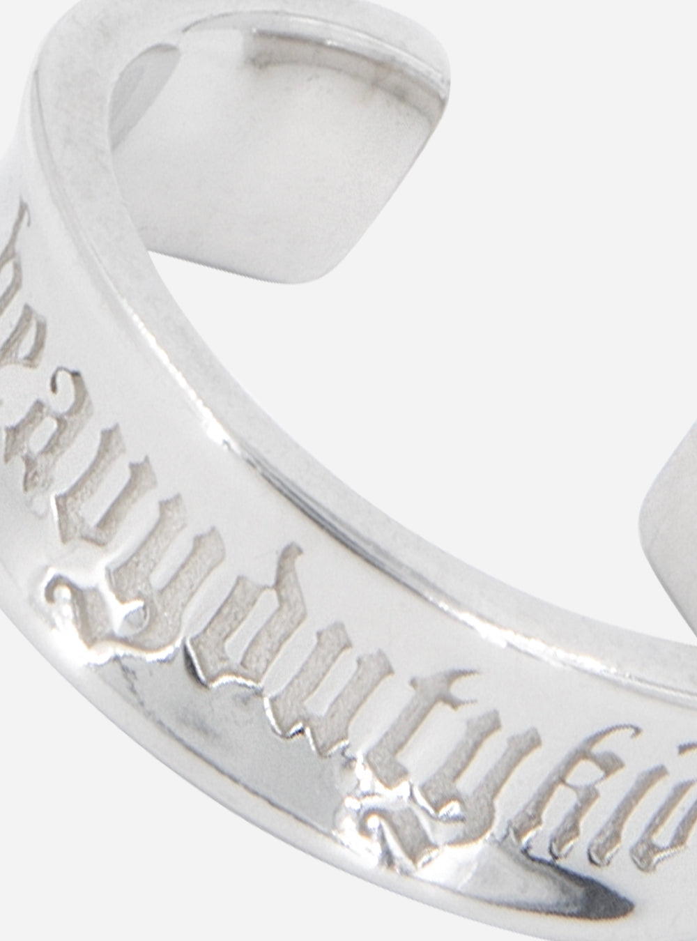 a silver MIDNIGHTFACTORY HEAVYDUTYKID cuff ring with writing on it.