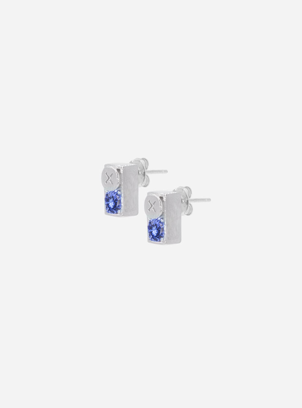 a pair of MIDNIGHTFACTORY Screwbox sapphire stud earrings on a white background.