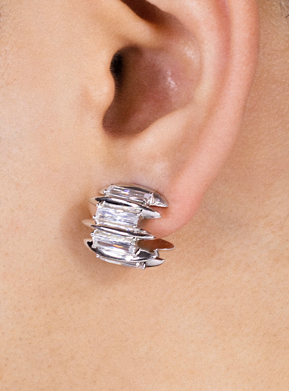 A woman's ear with a Talon eternity earring by MIDNIGHTFACTORY ear cuff.