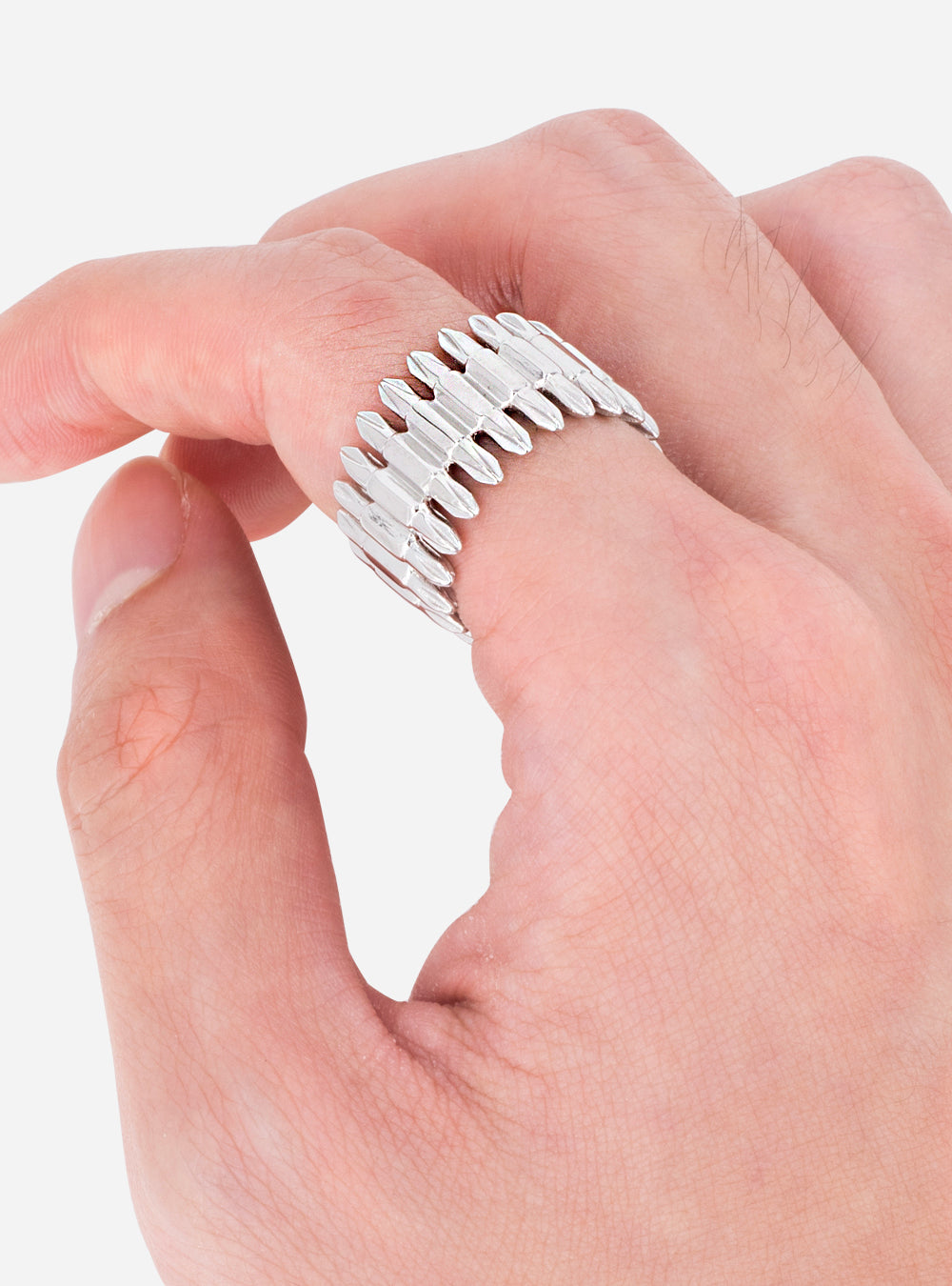 A person's hand is holding a MIDNIGHTFACTORY Driverbits eternity ring.