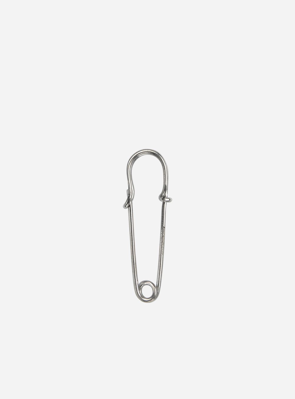 a small MIDNIGHTFACTORY silver pin on a white background.